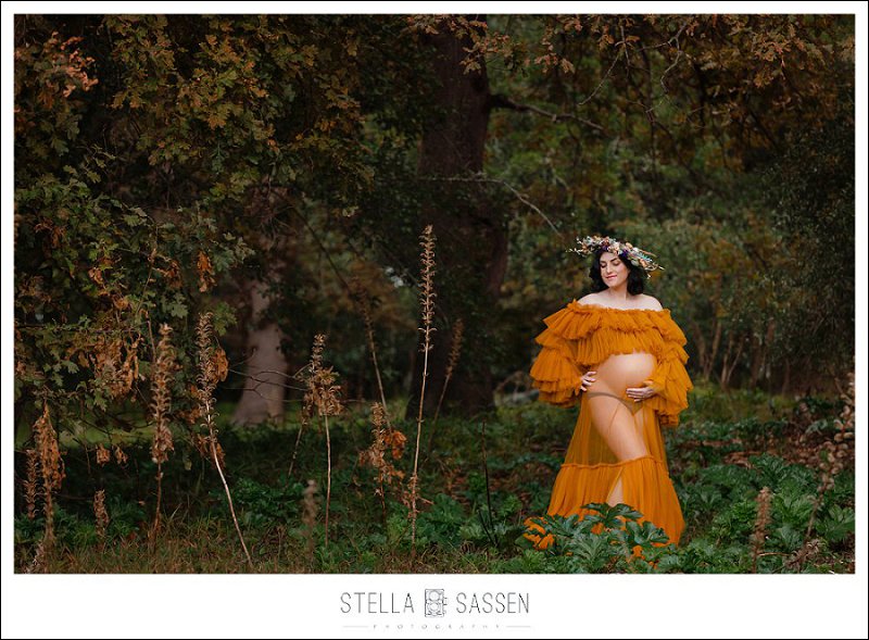 Maternity shoot in the forest with greenery and studio dress