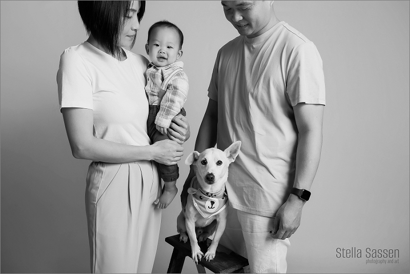 family and dog posing for family shoot with baby