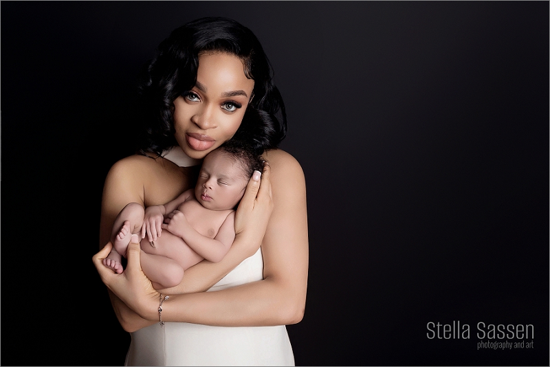 A mother gently holding her newborn in a cozy studio setting in Cape Town