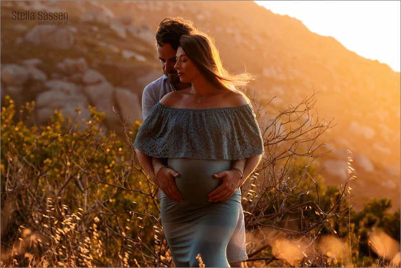 sunset photo of couple on Cape Town mountainside during maternity photo shoot