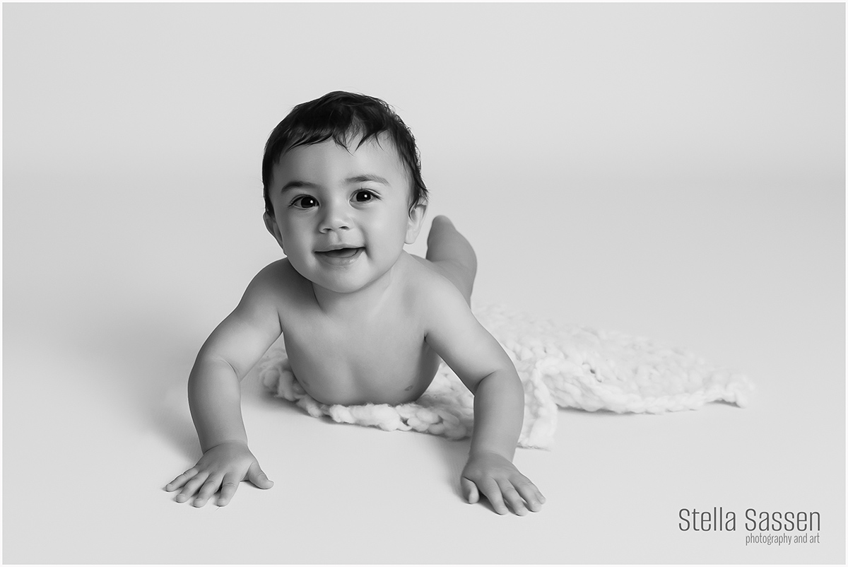 Toddler lying on tummy smiling at camera