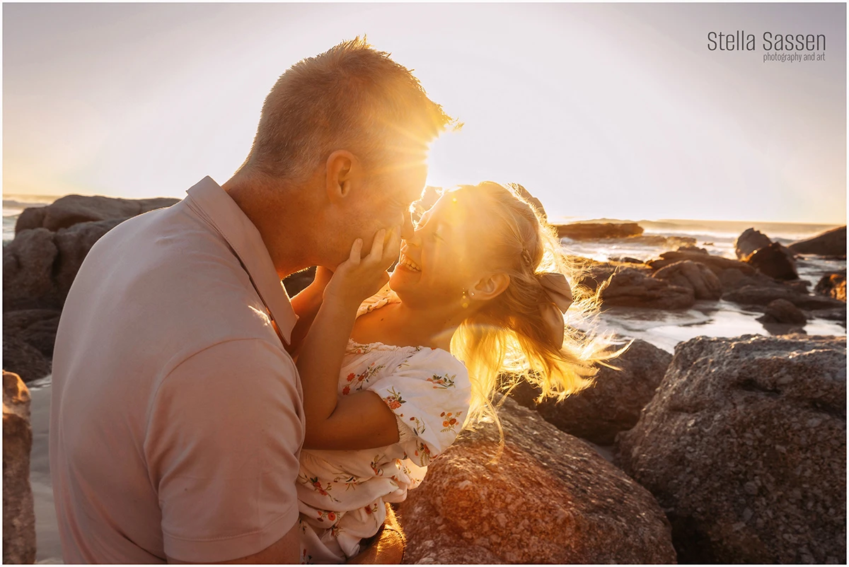 backlit photo of dad and little girl playing on beach in Cape Town during photo shoot