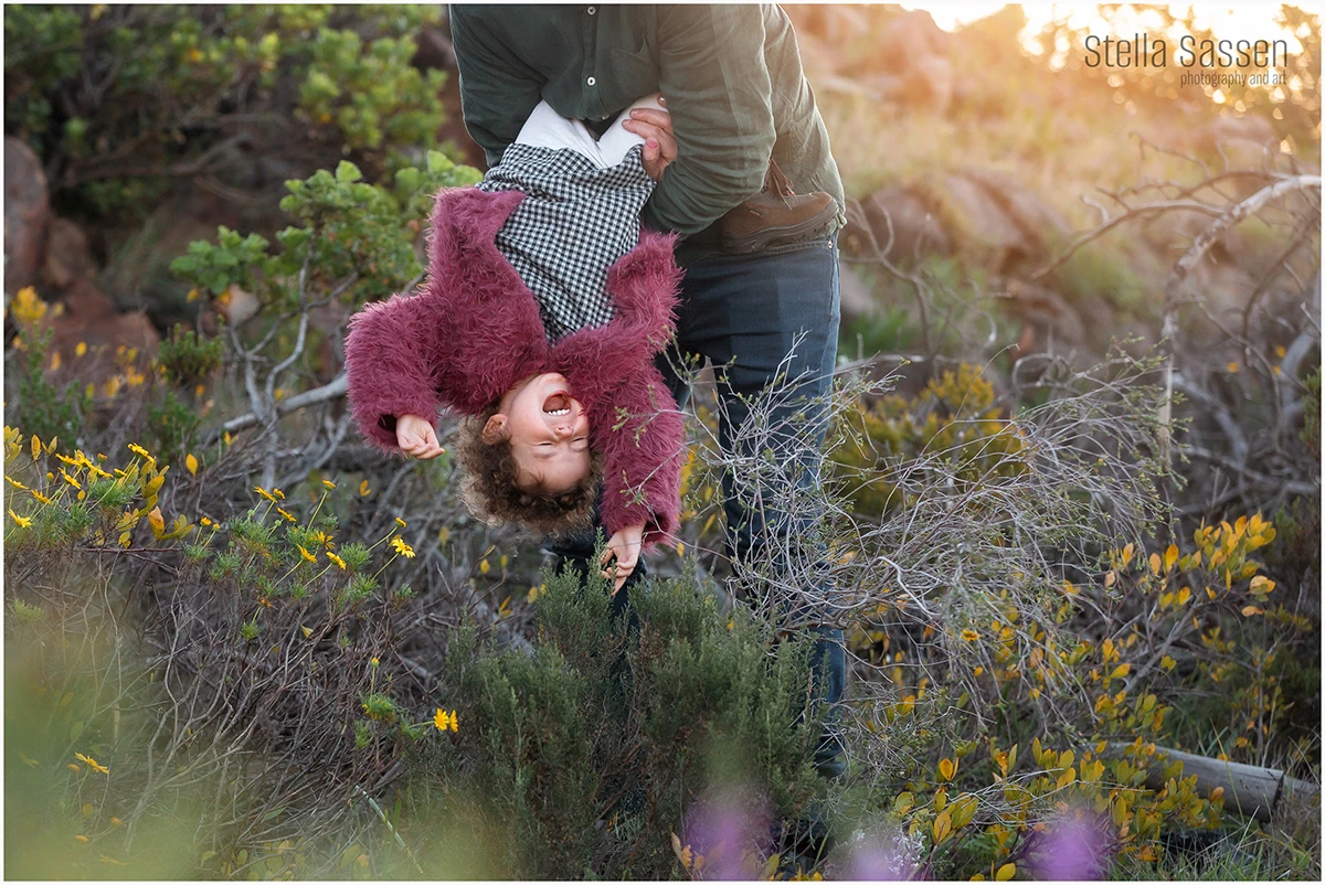 dad and toddler outside in nature having fun and laughing during family photo shoot